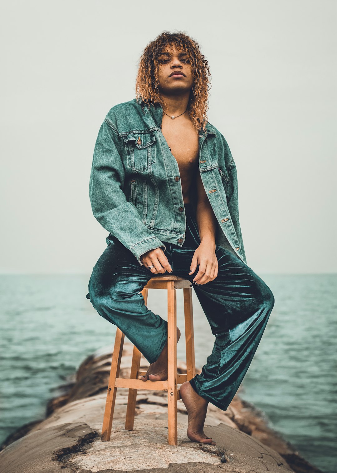 man sitting on brown wooden stool