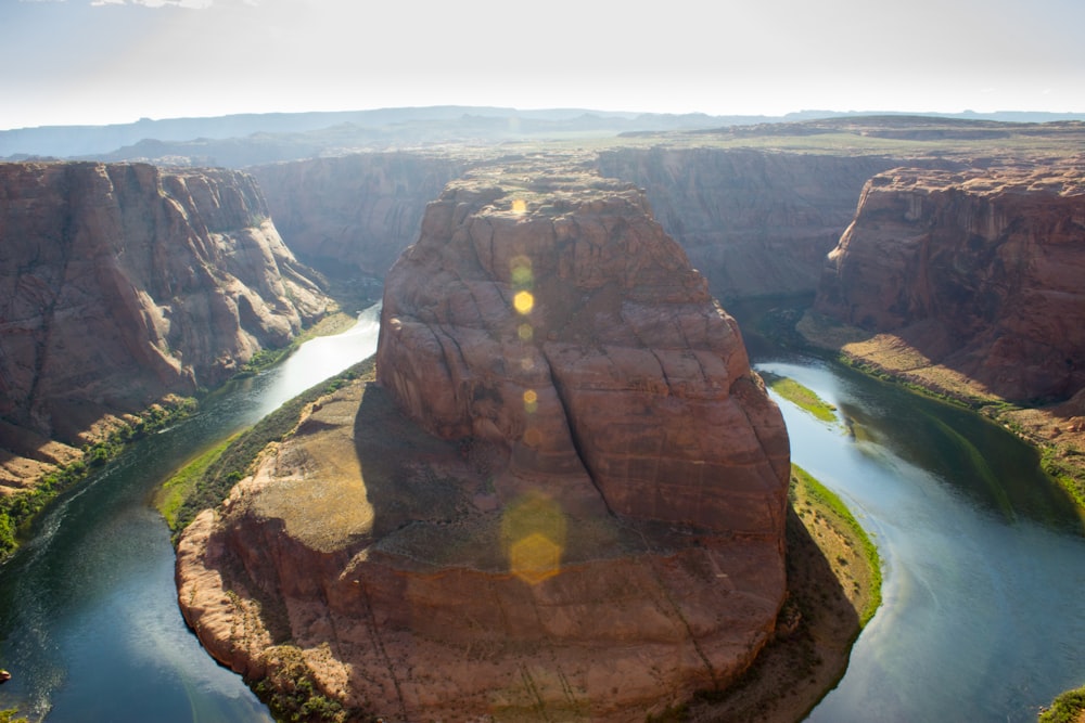 birds eye photography of rock formations and body of water during daytime