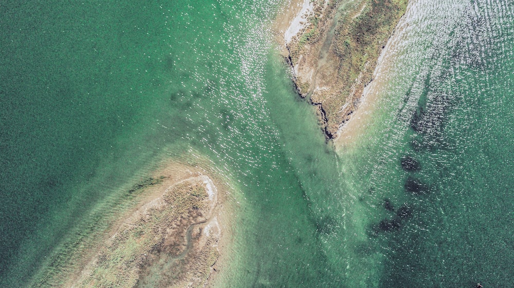 two islands surround by green body of water