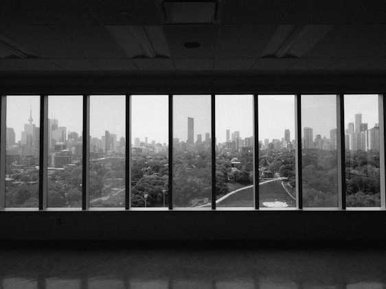 A panoramic view of Africa featuring bustling cities by the ocean, with visuals representing oil & gas, mining, and agrifood sectors alongside wild landscapes, all under a dark blue theme, showing Black African collaborators engaged in discussion.