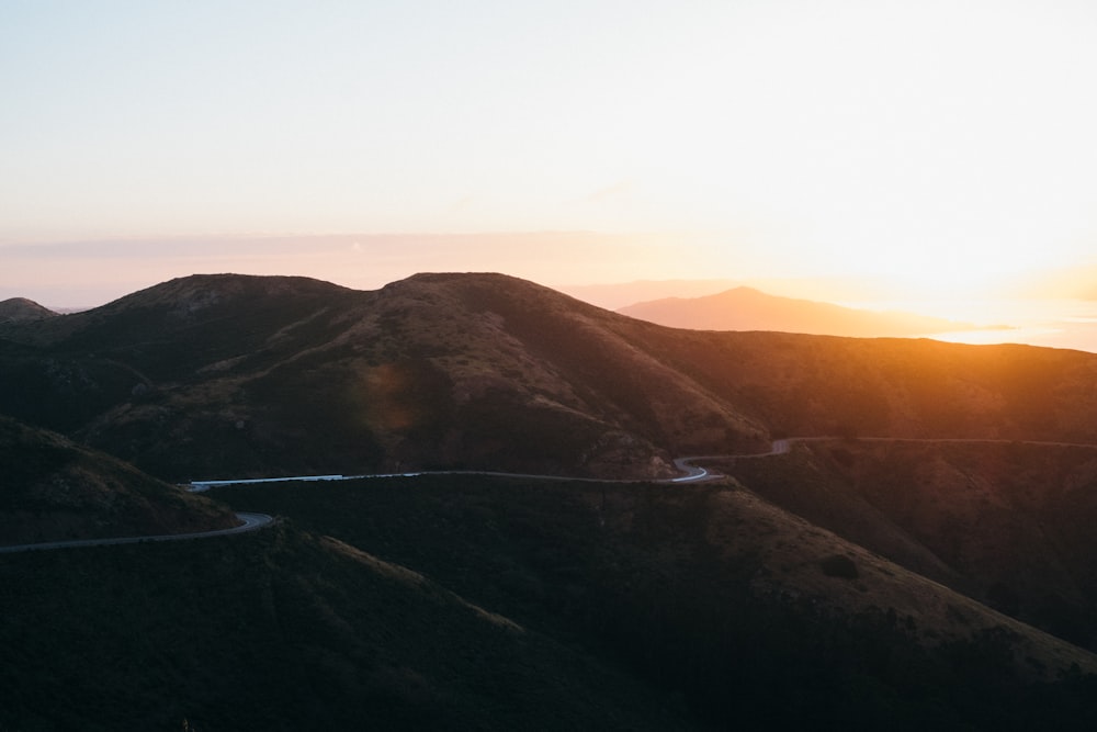 gray road beside mountains