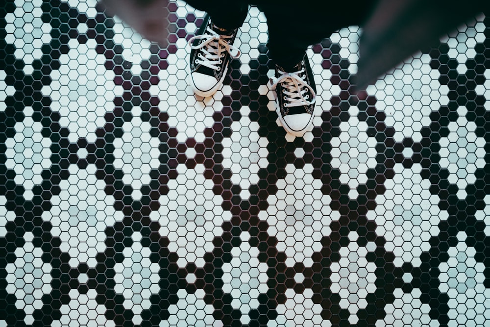 person standing wearing black sneakers