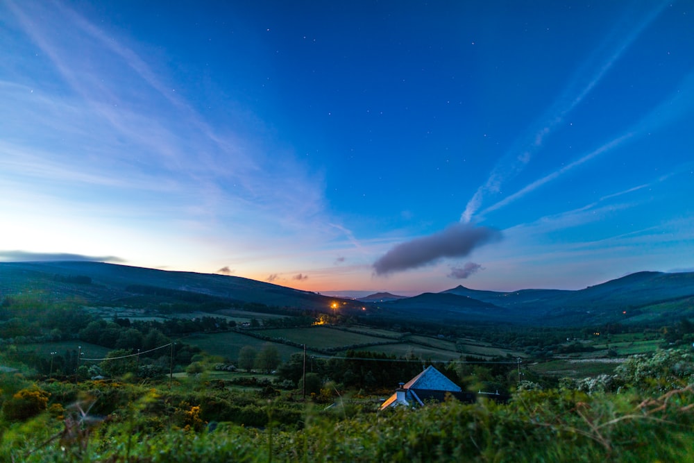 cabin near trees under calm sky