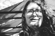 grayscale photo of woman wearing eyeglasses