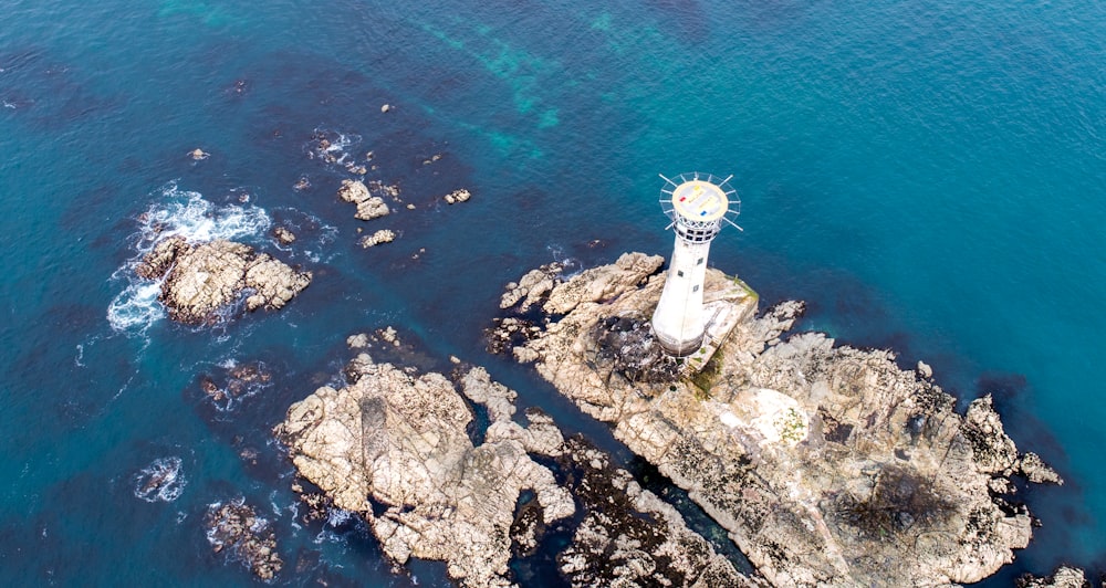 aerial photography of lighthouse near body of water