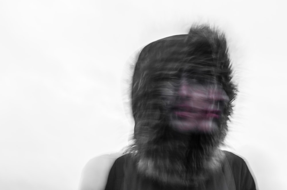 Espeluznante foto borrosa de la cara de una persona y una capucha peluda