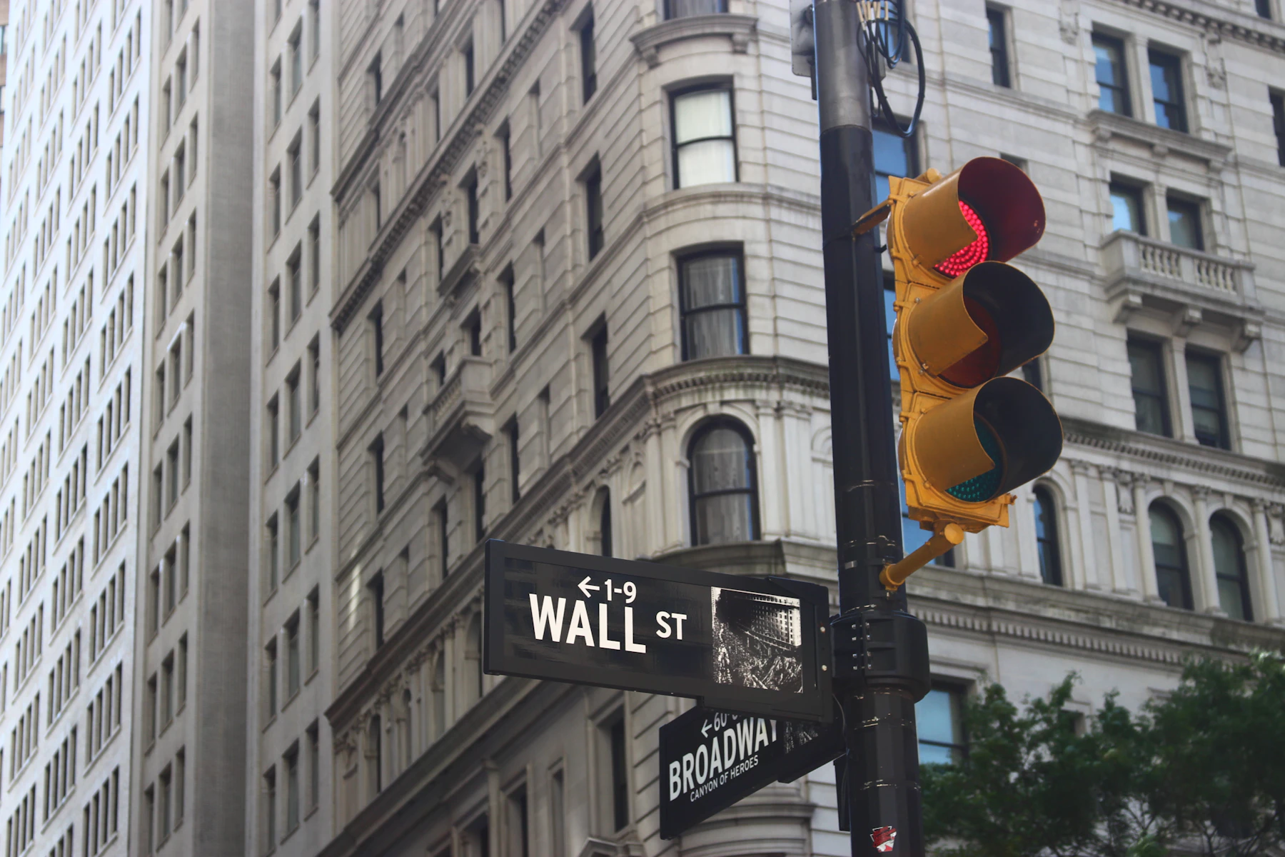 Lower Manhattan financial district with concrete commercial buildings in daylight.
