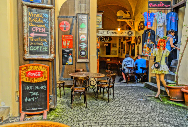 Interior of Ježkove oči bar with rustic wooden tables and exposed brick walls.
