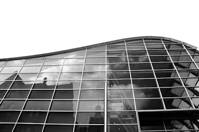 A sleek commercial building with glass facades reflecting the city skyline.