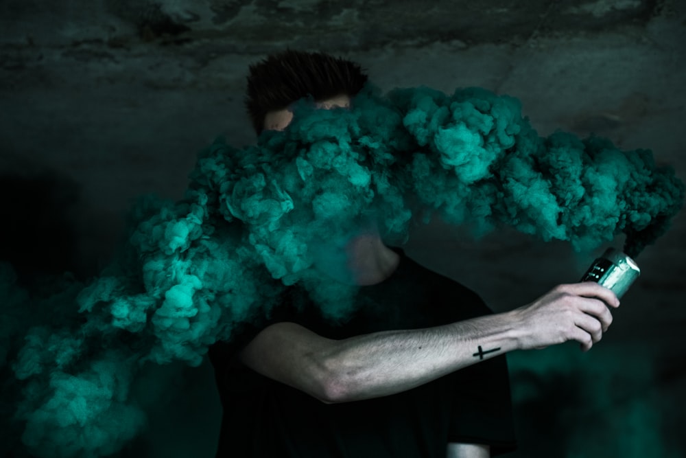 man holding can with smoke photo – Free Smoke Image on Unsplash