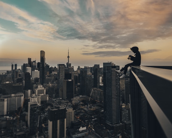 person sitting on top of the building