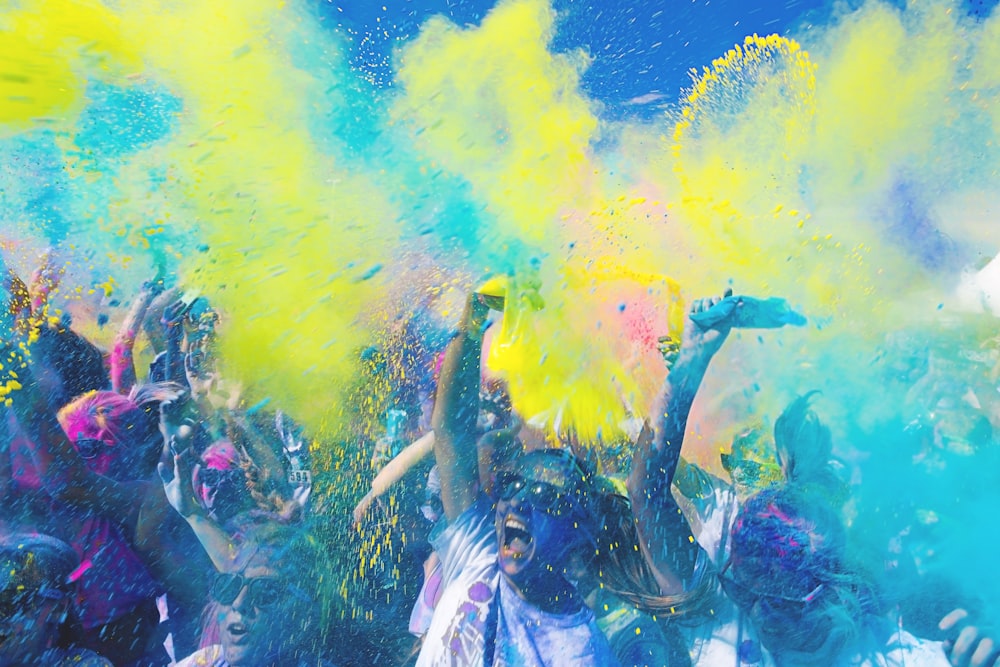 people holding pouches with colored powders