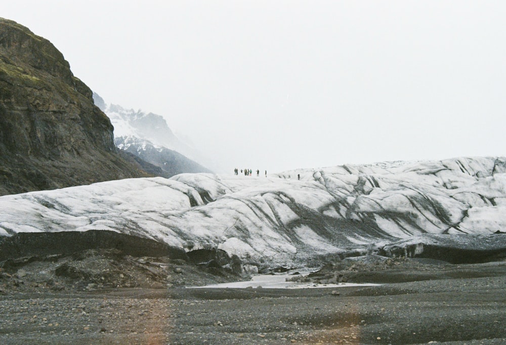 people standing on snow covered mountains during daytime