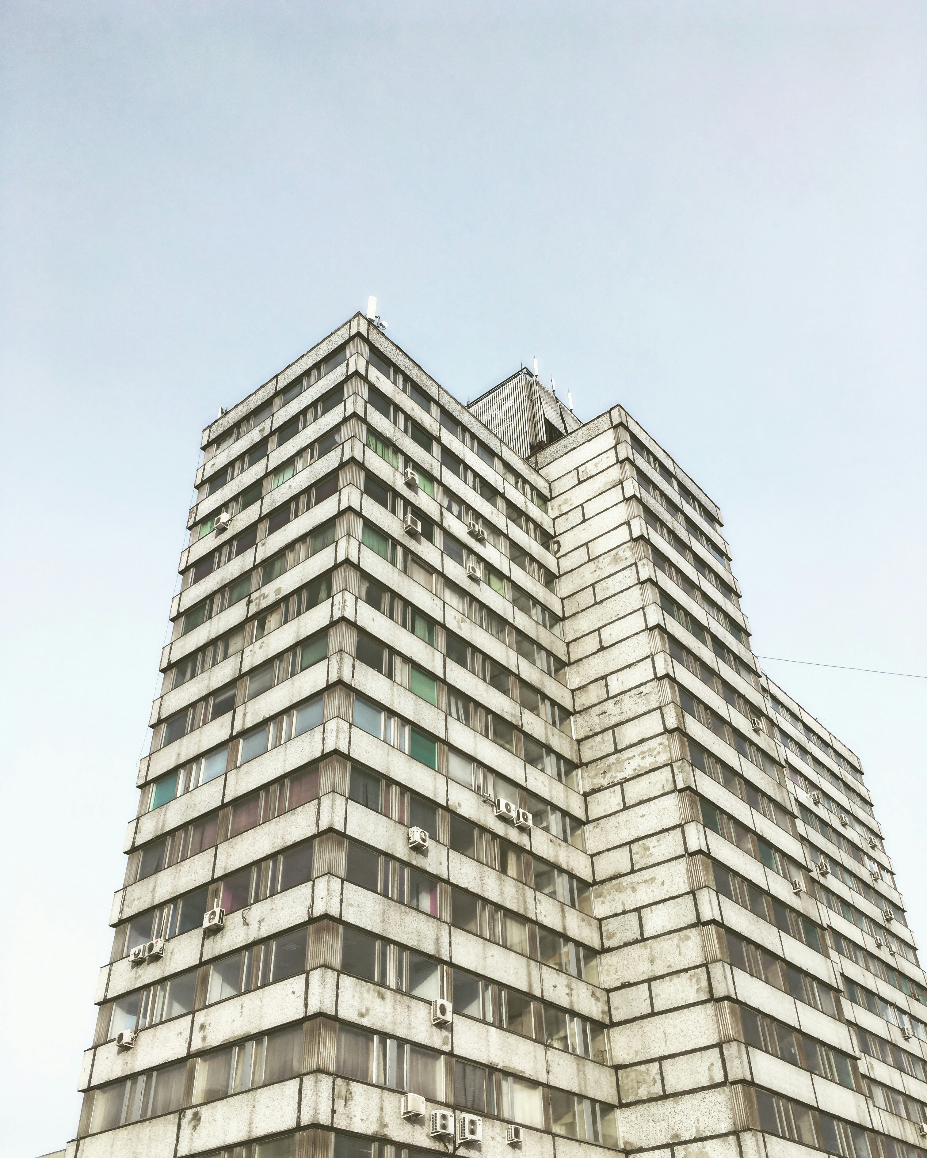 low-angle photography of grey high-rise building