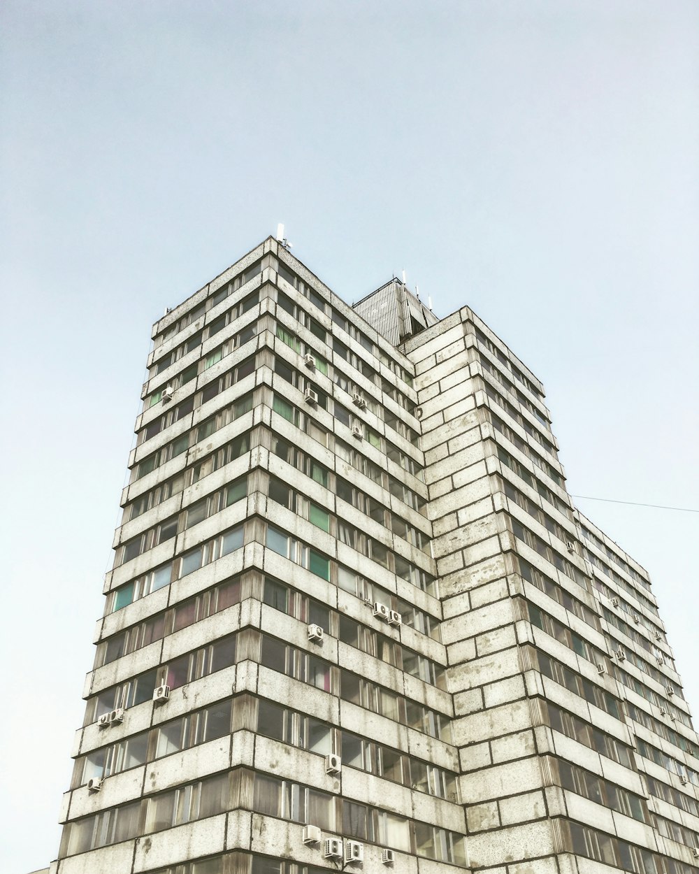 low-angle photography of grey high-rise building