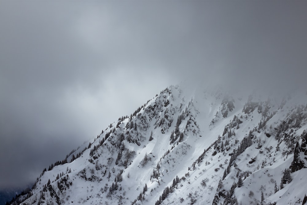 hills covered with snow over nimbus clouds