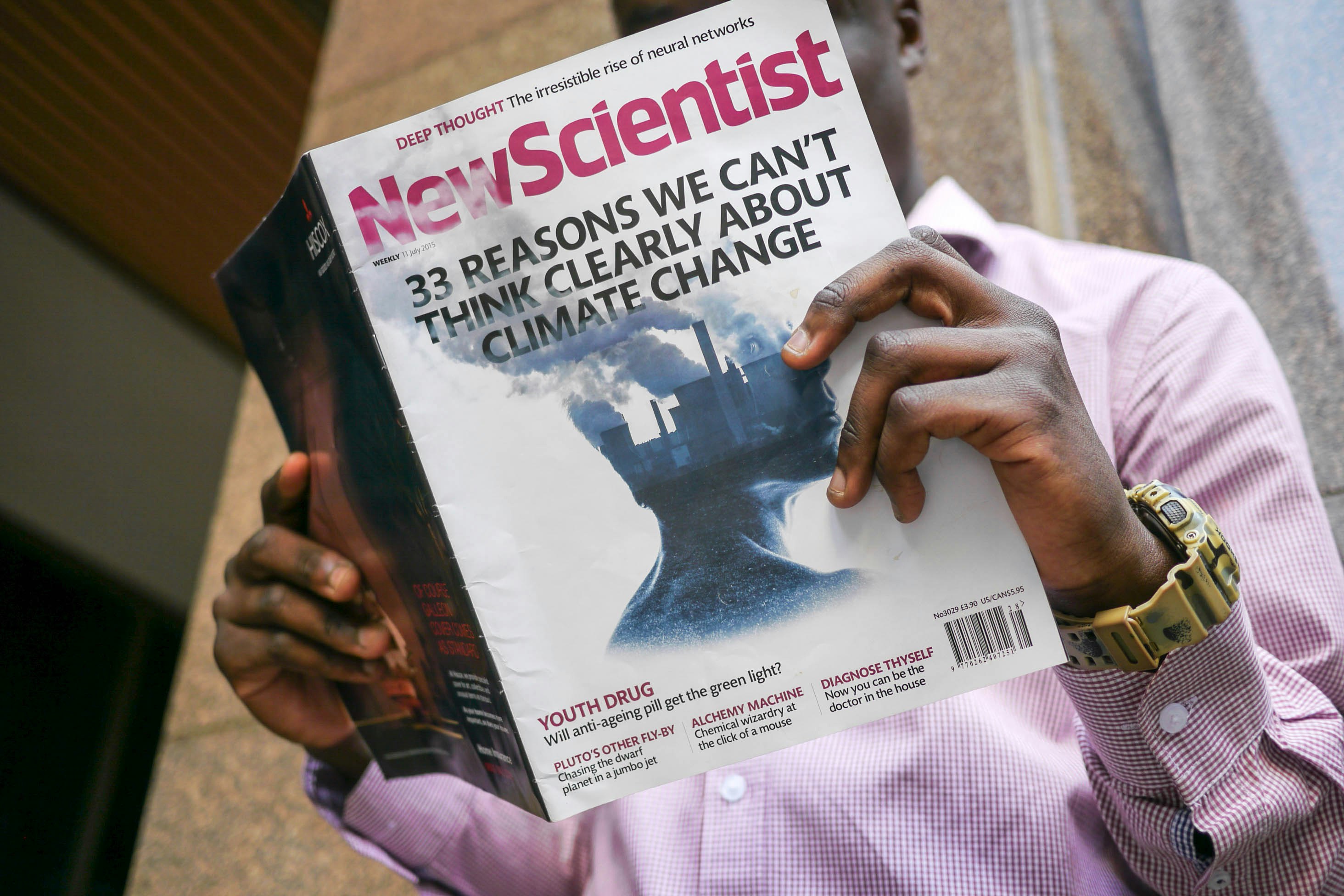 man reading New Scientist book
