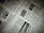 A close-up of a newspaper with multiple pages spread out. The text is written in a non-Latin script, possibly Chinese. There are also images within the articles, including one with the word 'NEWS'. The pages are slightly overlapping, creating an organized yet informal layout.