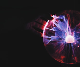 human hand holding plasma ball