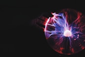 human hand holding plasma ball