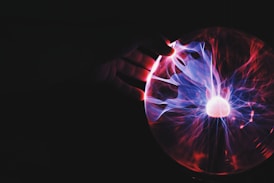 human hand holding plasma ball