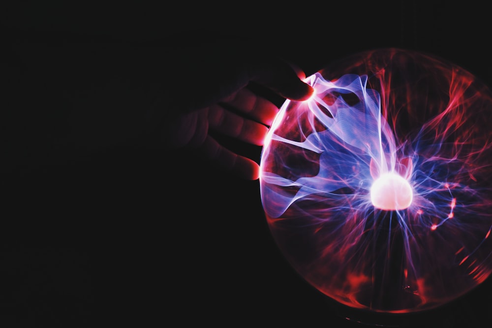 human hand holding plasma ball