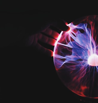 human hand holding plasma ball