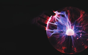 human hand holding plasma ball