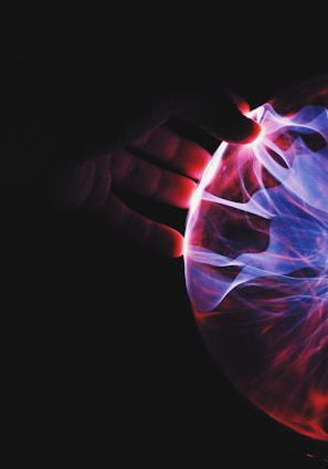 human hand holding plasma ball