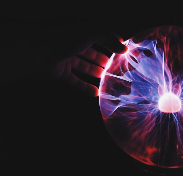 human hand holding plasma ball