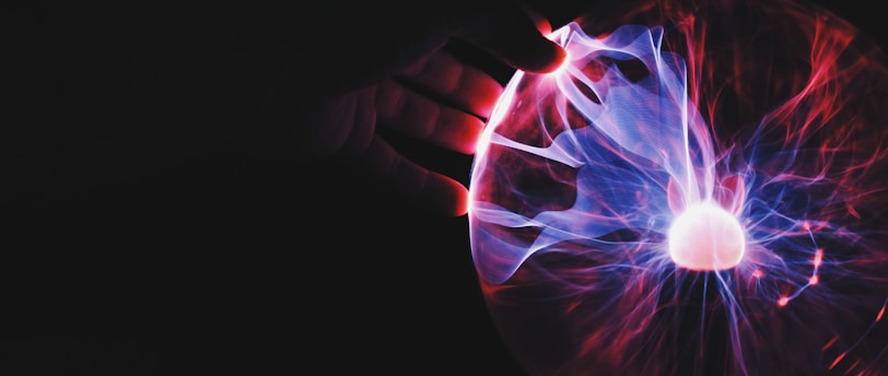 human hand holding plasma ball