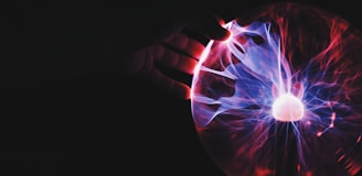 human hand holding plasma ball