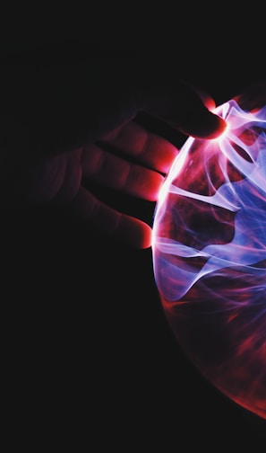 human hand holding plasma ball