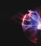 human hand holding plasma ball