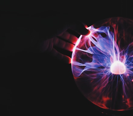 human hand holding plasma ball