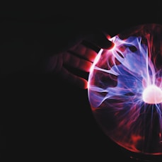 human hand holding plasma ball