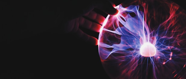 human hand holding plasma ball