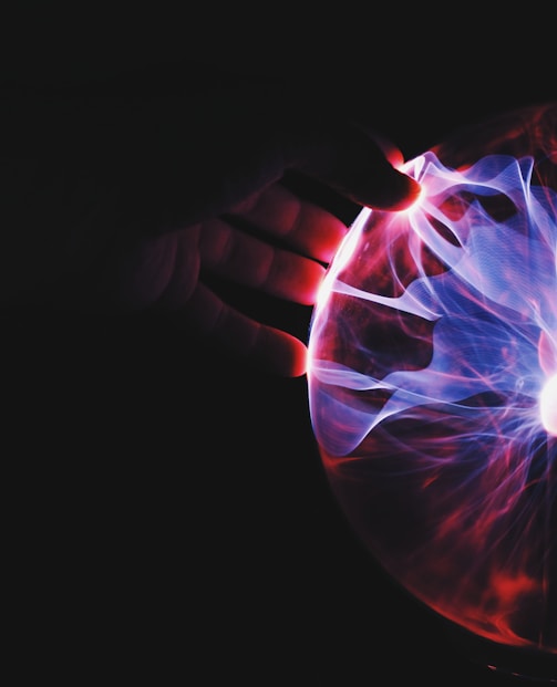 human hand holding plasma ball