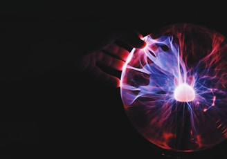 human hand holding plasma ball