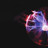 human hand holding plasma ball