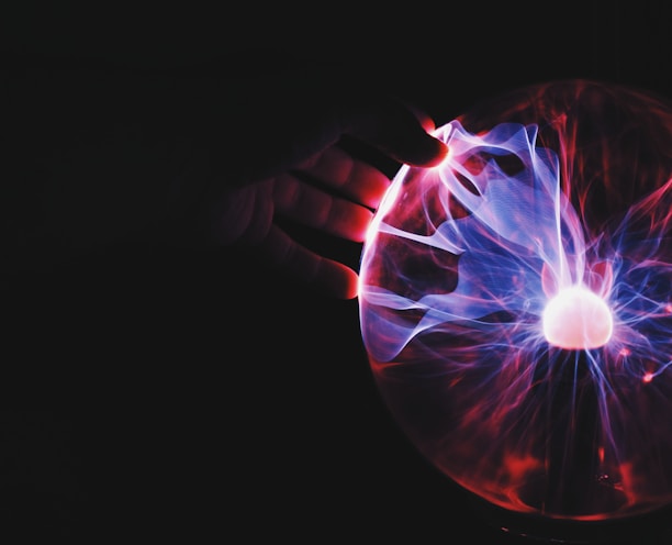 human hand holding plasma ball