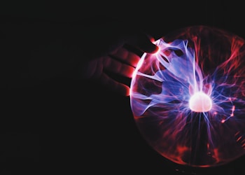 human hand holding plasma ball