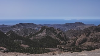Panoramic view of a freshly expanded mining terrain with clear blue sky overhead.