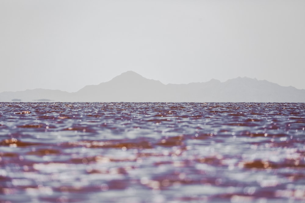 ocean waters with mountain at the distance