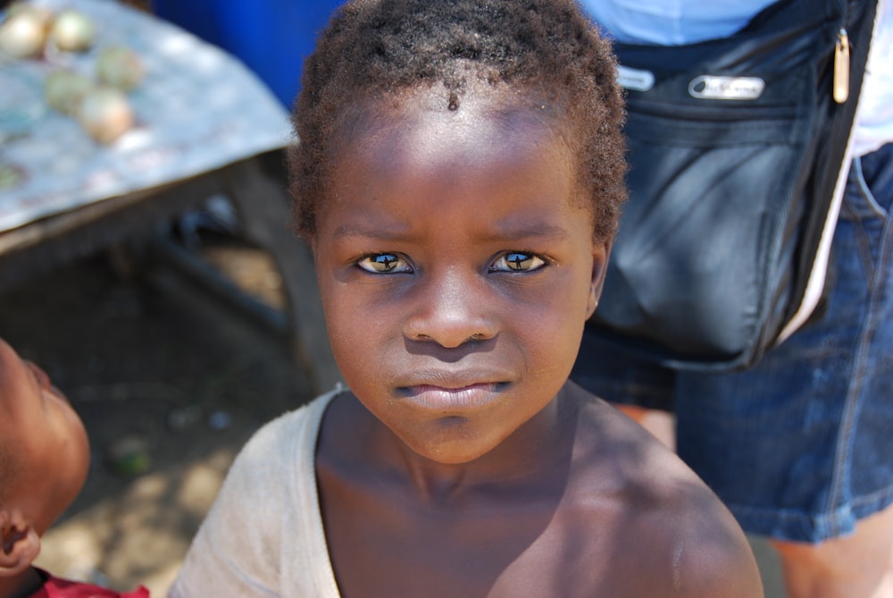 closeup photography of child wearing white top