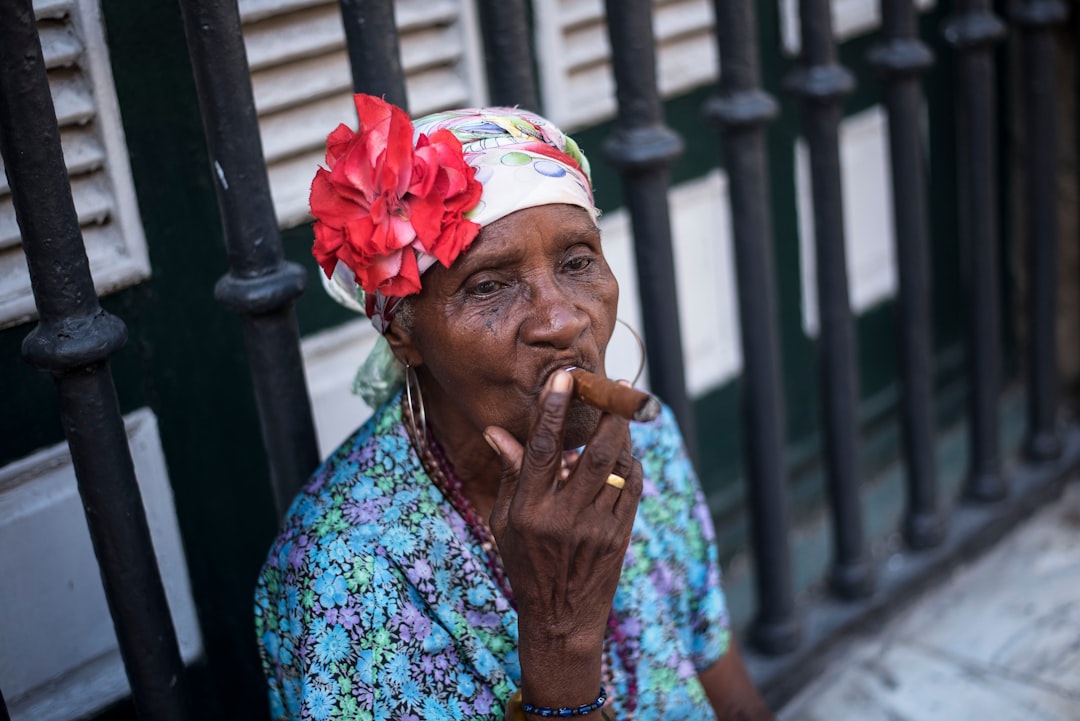 Old brown woman sucking on a cigar