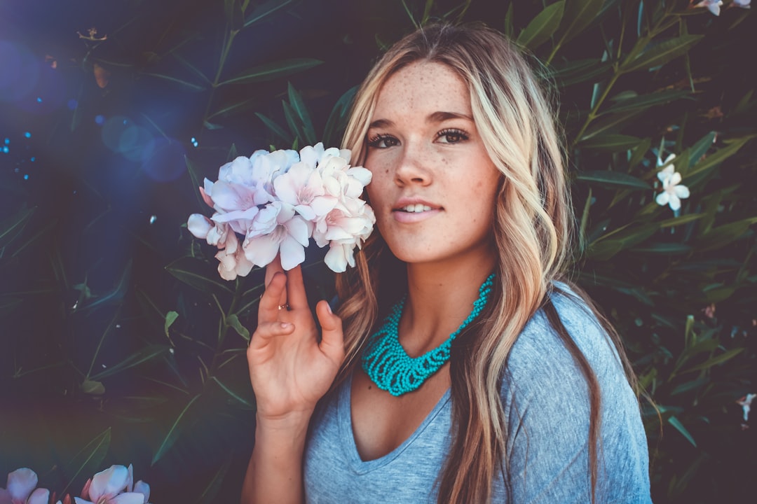 woman holding the white flowers beside her face