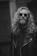 grayscale photo of man in leather jacket