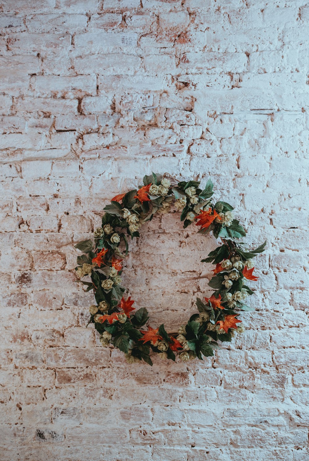 green, white, and orange floral wreath