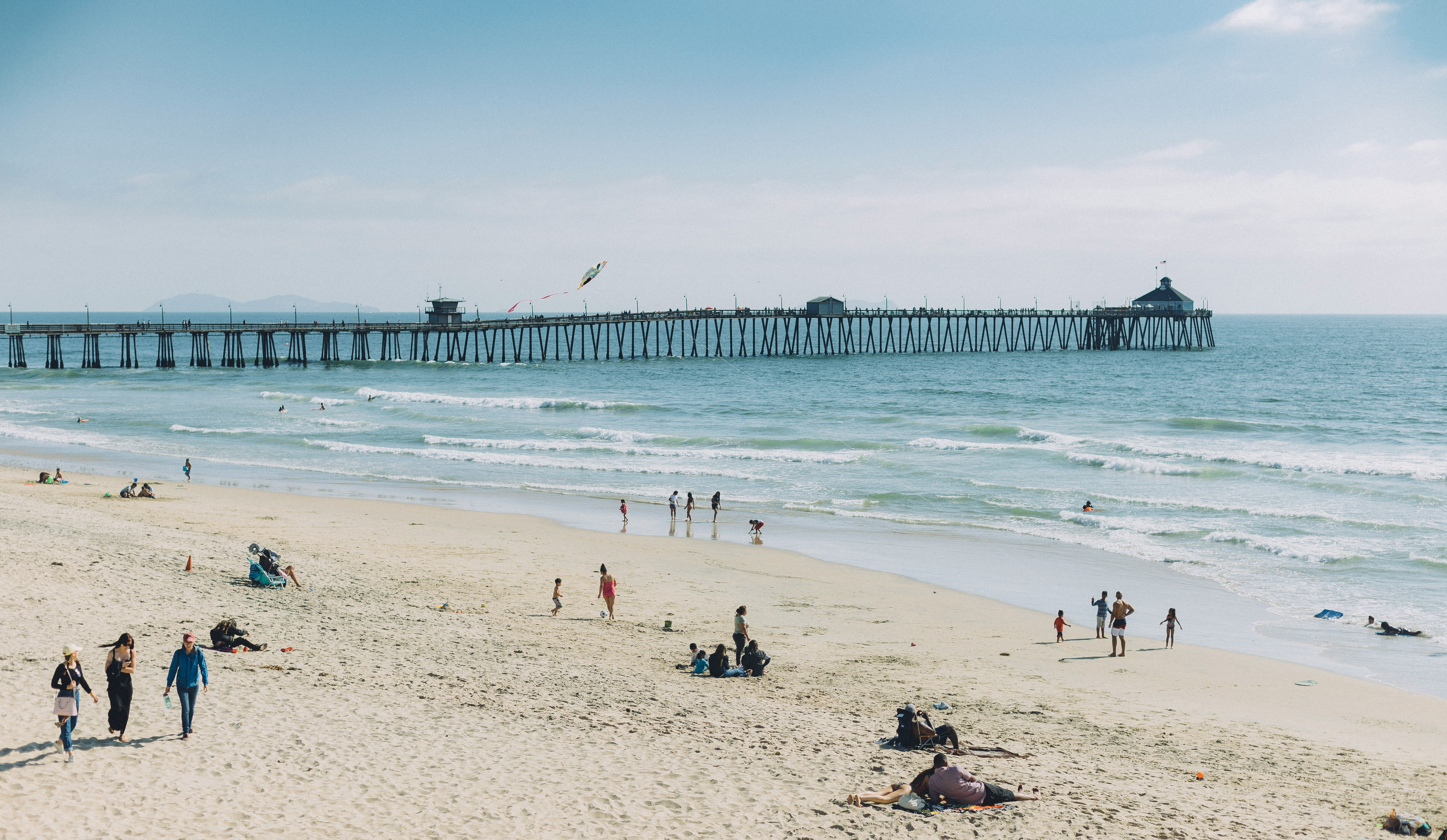 people at the beach swimming during daytime